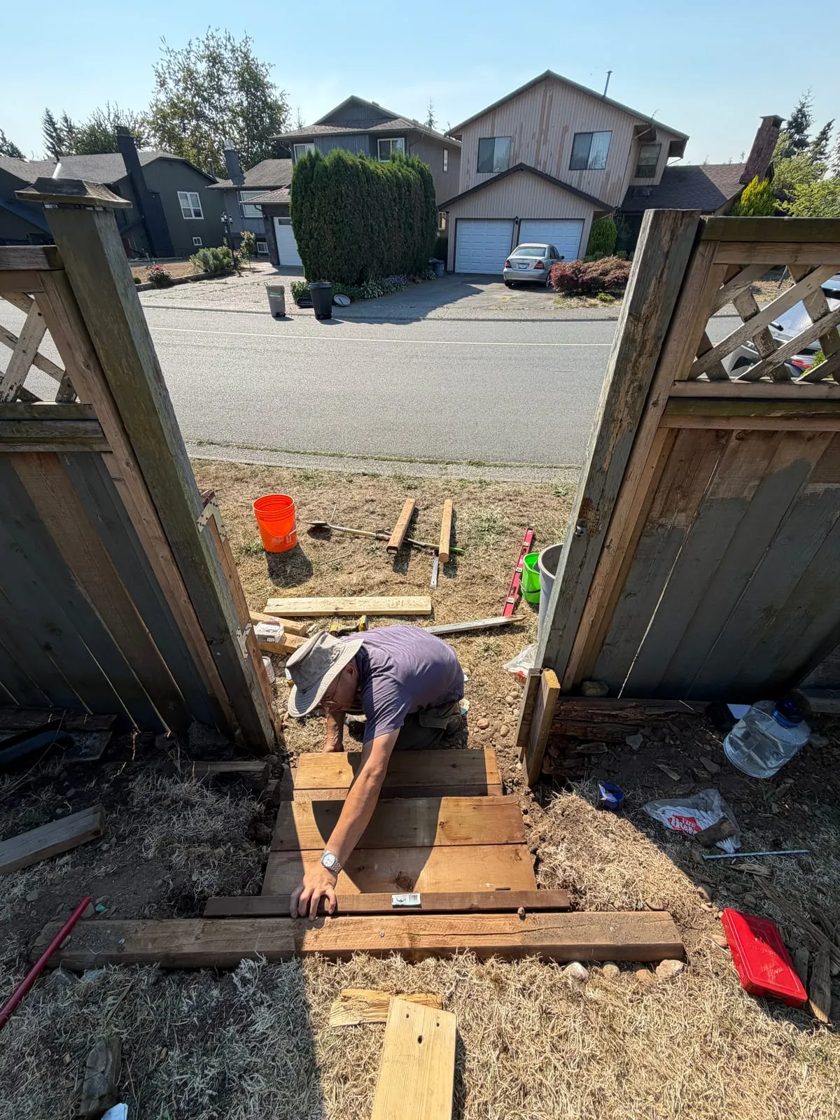 Setting and levelling the lower treads for new backyard steps.