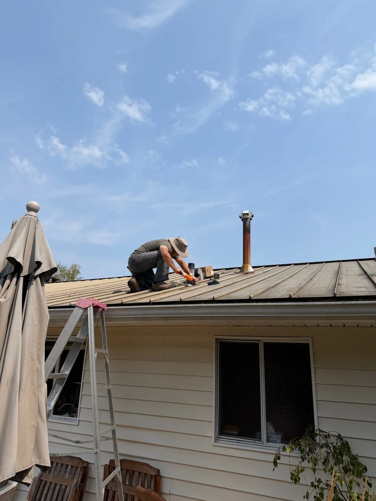 Sealing an exposed roof detail during a leak repair.