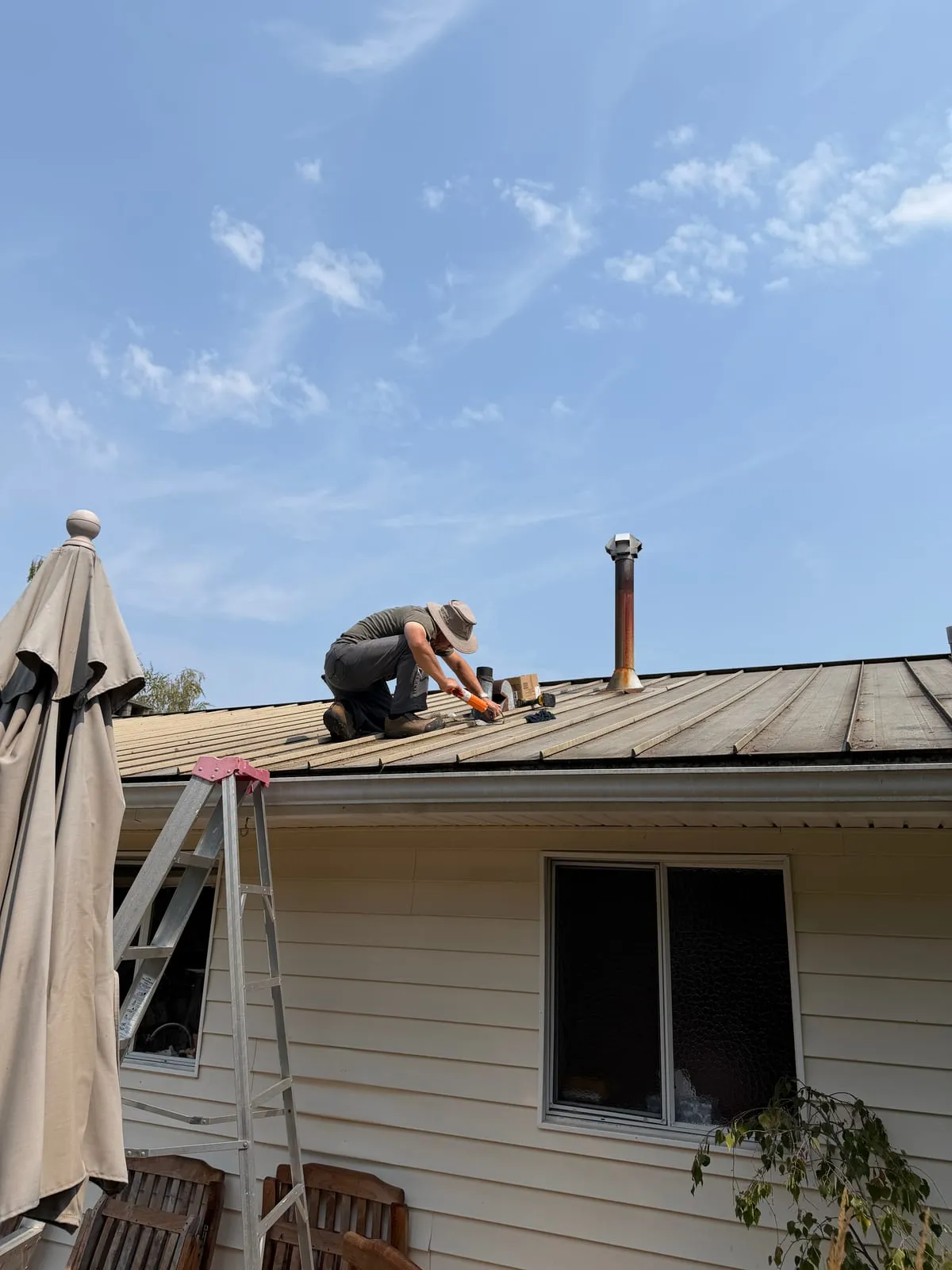Sealing an exposed roof detail during a leak repair.