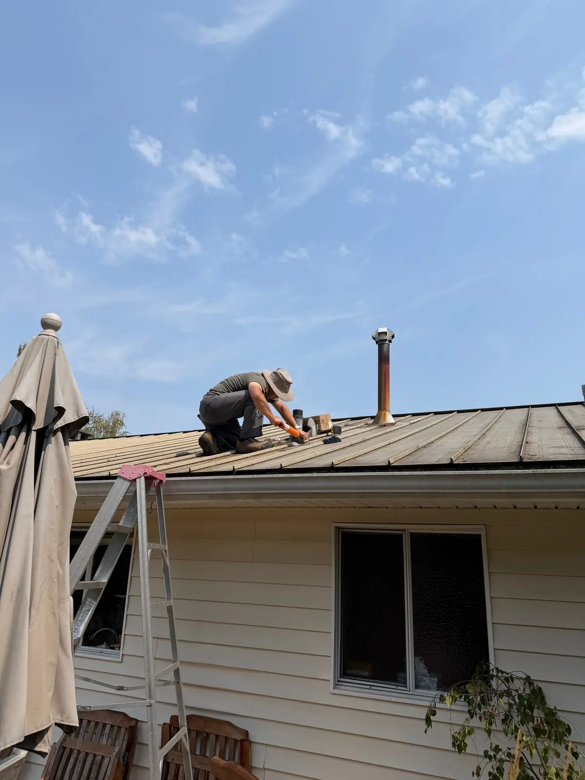 Sealing an exposed roof detail during a leak repair.
