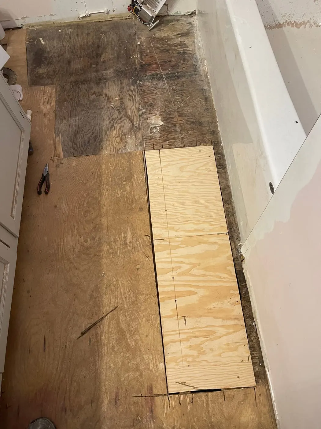 New subfloor scribed to fit around the fixtures.